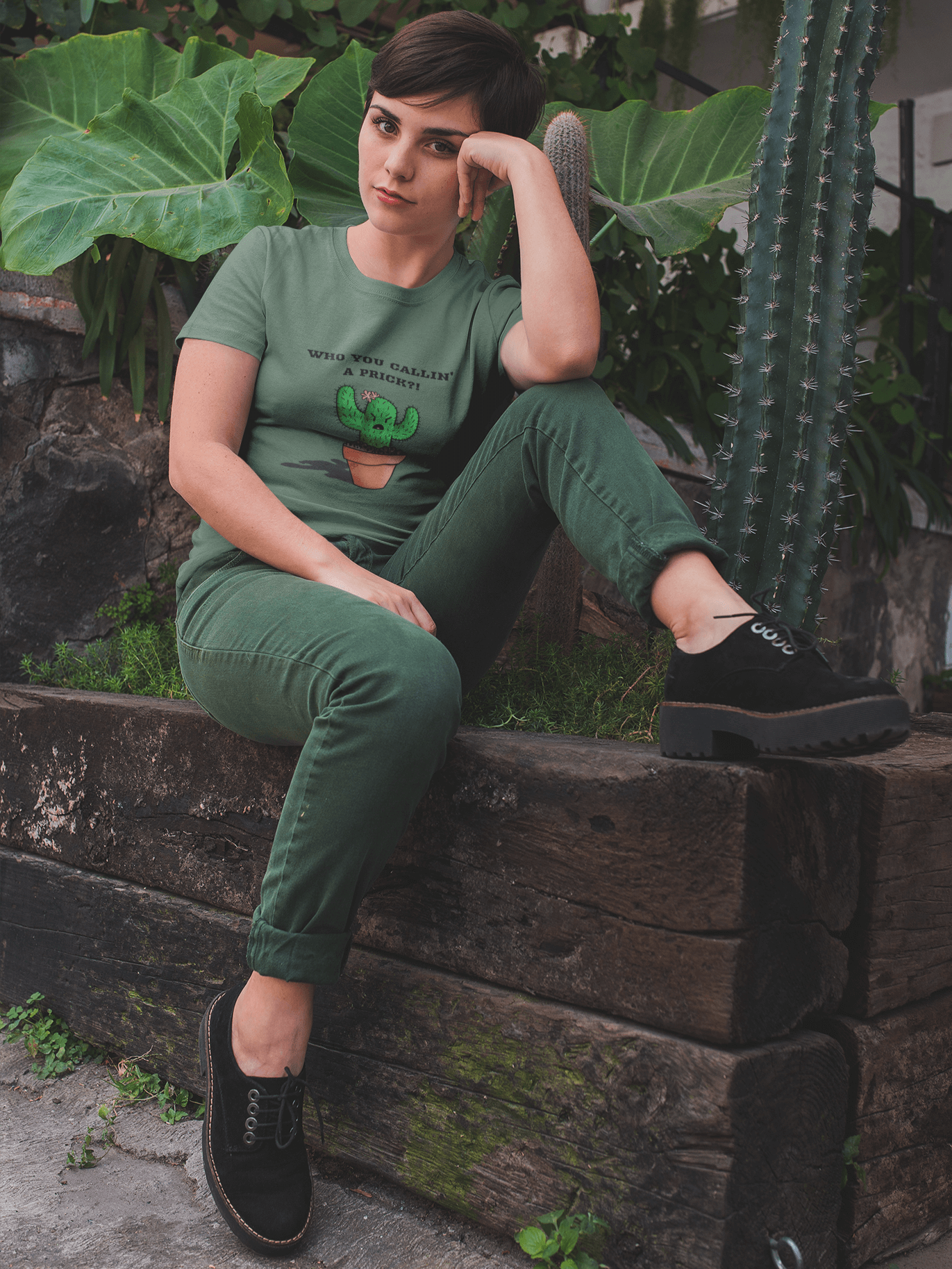 Woman sitting by cactus wearing a Rose Jane Designs Prickly Cactus "who you callin' a prick?!" t-shirt